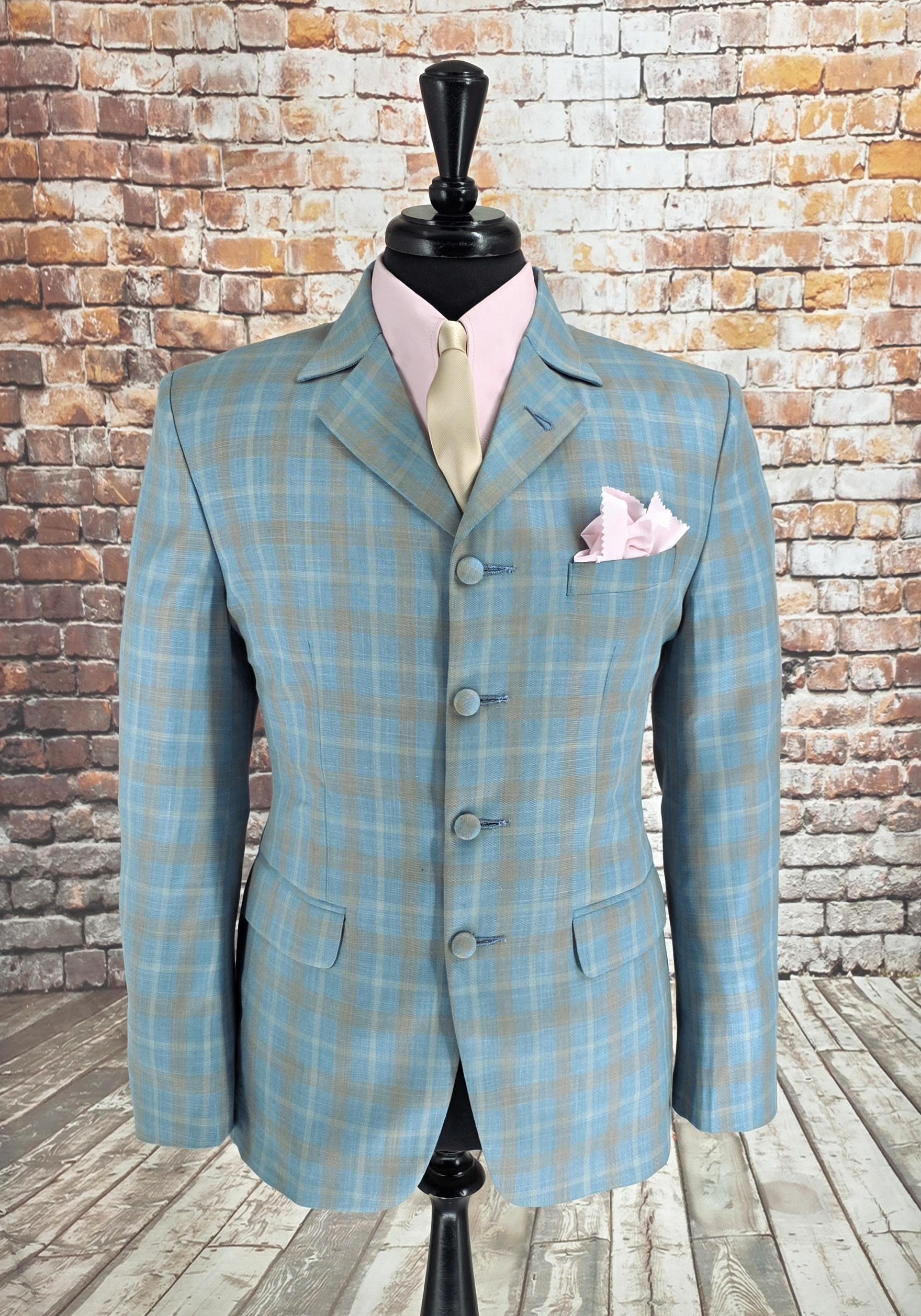 The Ashworth suit jacket front with pink shirt and gold tie styling