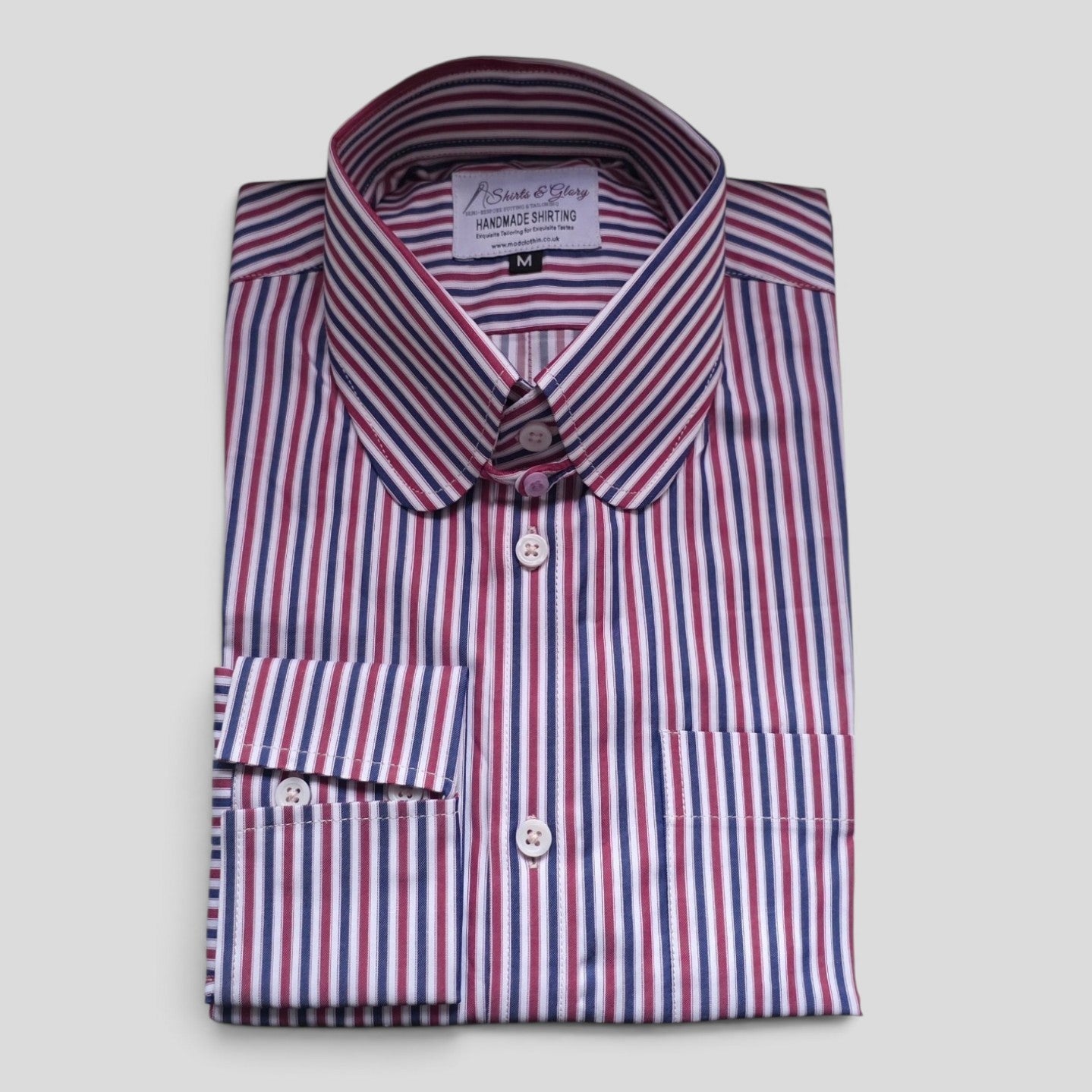 Guy muted red, white and navy stripe penny tab collar shirt folded, showing full front view