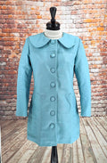 Close-up of Miranda pale blue lambs leather coat with rounded collar and covered buttons
