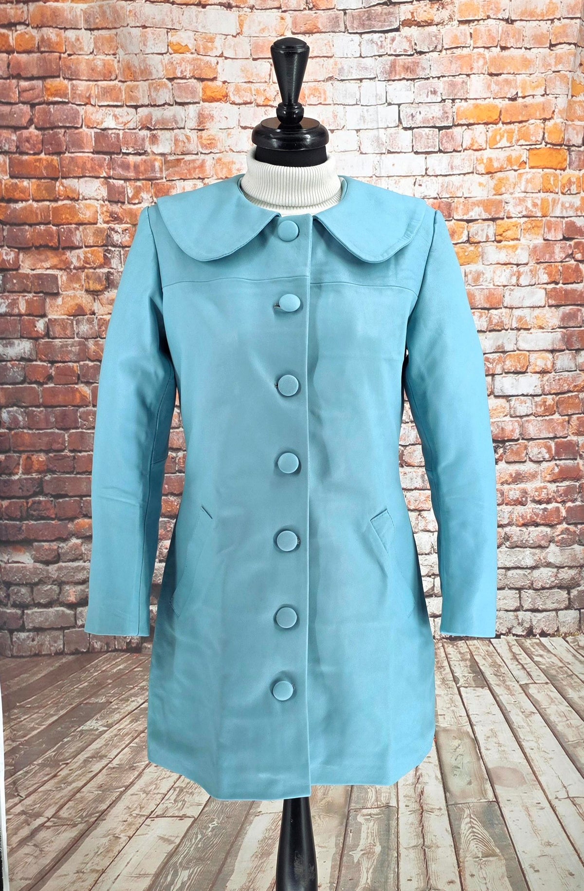 Close-up of Miranda pale blue lambs leather coat with rounded collar and covered buttons