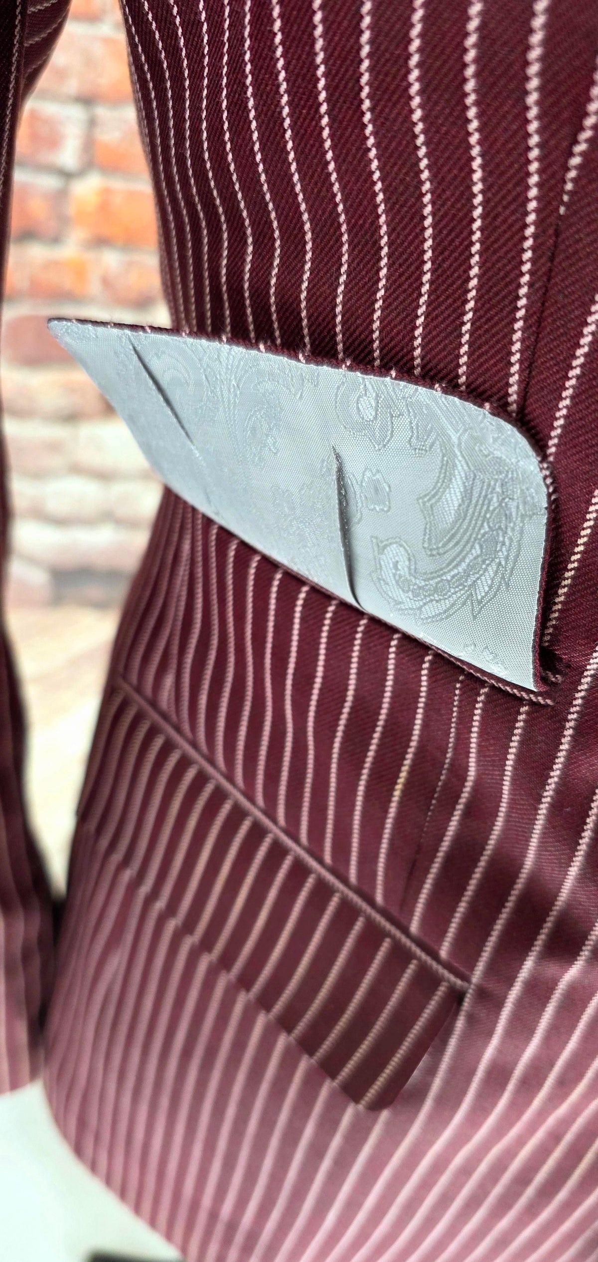 Close-up of the burgundy pinstripe wool-blend cloth and pocket