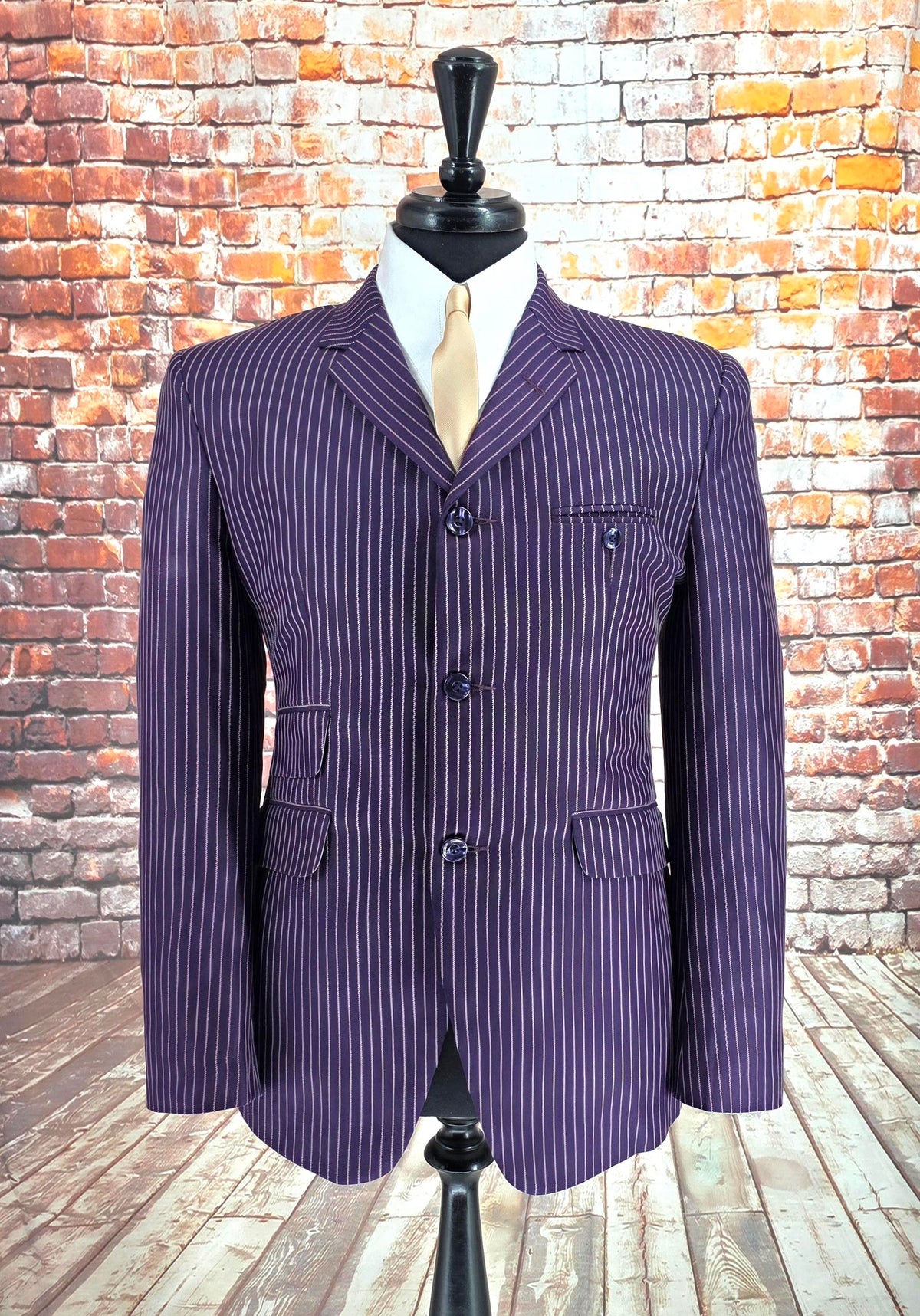 Close-up of a button and stitching on the Leith purple pinstripe blazer
