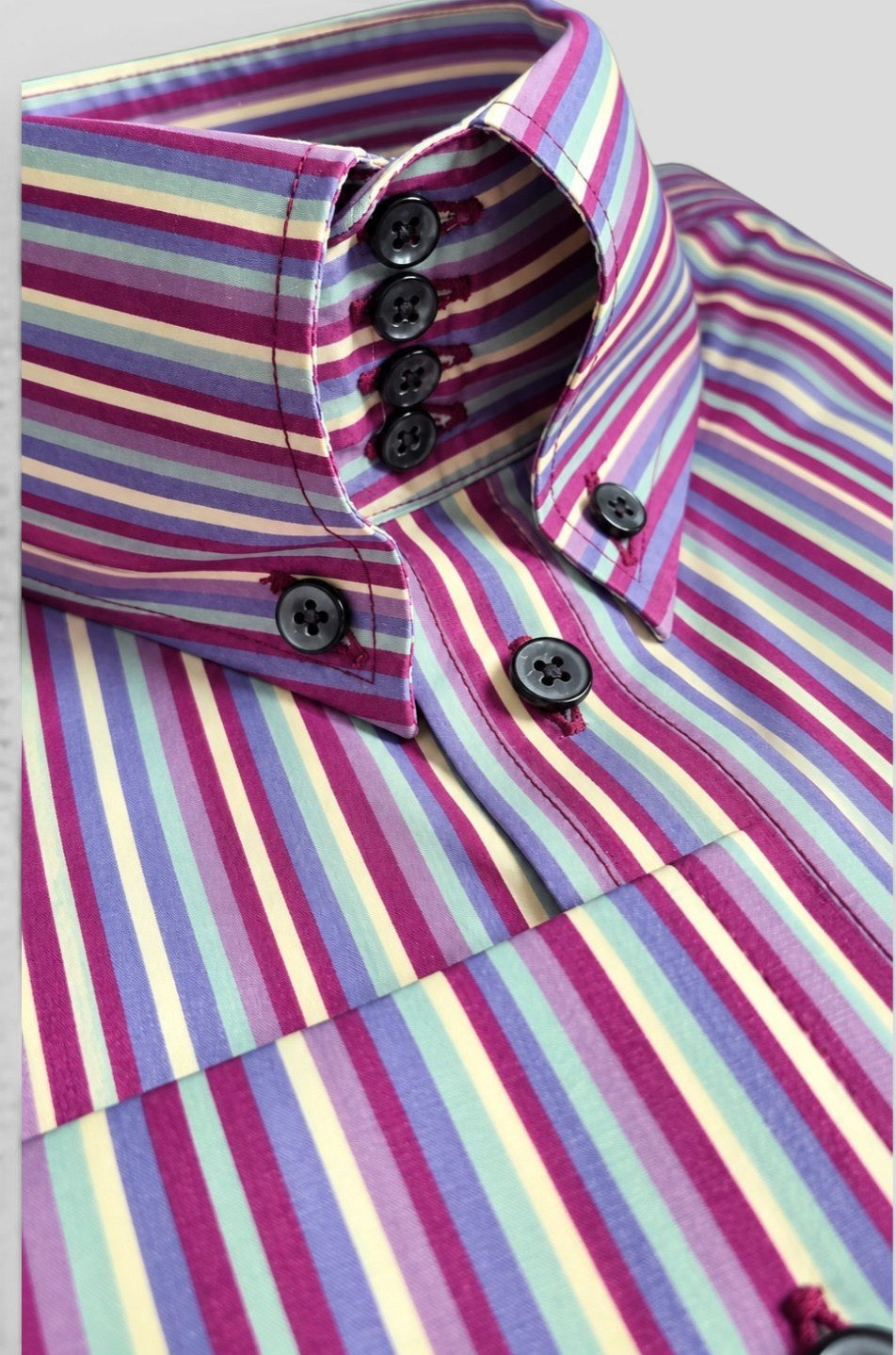 Close-up of Milo multi-stripe shirt showing high four-button collar and stacked button placket detail