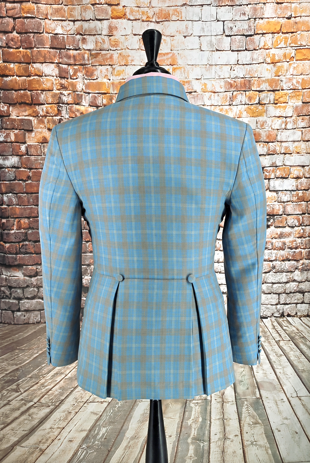 The Ashworth suit jacket showing pleat‑button back in blue and tan plaid