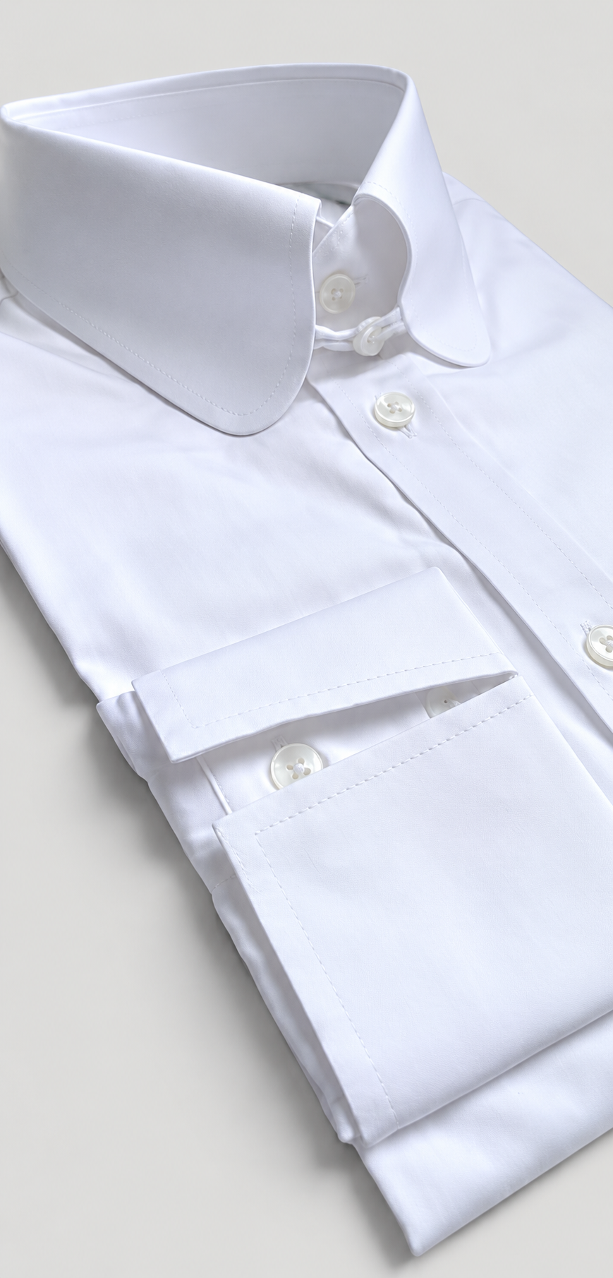 Close-up of Percy white shirt showing round collar and double-button barrel cuff detail